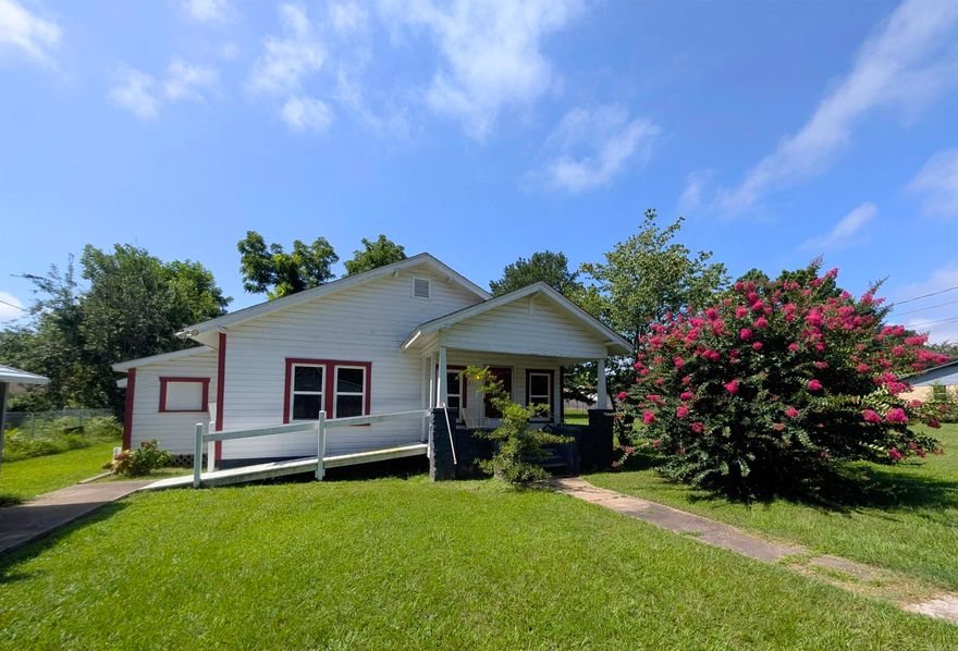 Move right in and make it home! Wheelchair accessible with tiled roll-in shower, newer kitchen cabinets, brand new flooring in the kitchen, primary bedroom and living room, newer appliances, energy efficient windows, walk in master closet! Extra insulation in the walls, extra wide doors for wheelchair access. Even has ramp to the front porch. Carport, nice outbuilding, garden area, landscaping and fencing on a huge lot!
