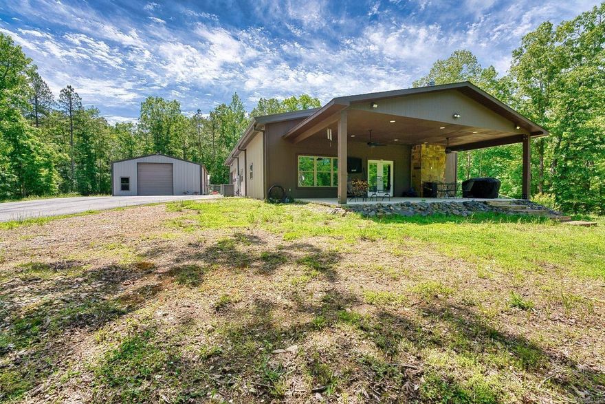 7 acres of private woodland yet just 10 minutes from town. This 2-bedroom, 2-bath barndominium blends modern luxury with rustic charm and features an open-concept gourmet kitchen with custom cabinetry, granite countertops, and a large island bar. The expansive living room offers soaring ceilings, a cozy fireplace, and picturesque forest views. Designed for efficiency it has 6-inch exterior walls with R-29 insulation, a tankless water heater, and a 22kW whole-home generator. The 2-car garage leads into a spacious mudroom/pantry and laundry room.     Outdoor living is a breeze on the massive covered porch overlooking the serene landscape.   Enjoy the 30x40 shop, complete with a restroom and a dedicated hobby room—ideal for woodworking, creative projects, or equipment storage. This property offers a rare combination of serenity, high-end craftsmanship, and city conveniences.