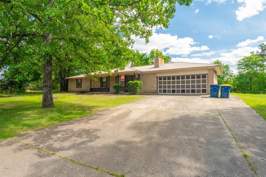 Come out and visit a well-maintained 3/2 home that sits on 1 Acre! This home features a fenced backyard with plenty of room for outdoor activities, a wood-burning fireplace with blowers, 31' x 11' shed/shop, that is connected to electricity, and an inviting covered front porch and back deck. There's a spacious kitchen that features a large walk-in pantry, double oven, microwave, two refrigerators (one in the kitchen and one in the garage). This home is equipped with a new metal roof that was installed in 2022 and a new full HVAC system in 2024! The most unique aspect about this home is that it's located in quiet cut-de-sac, that has direct access to a small lake; perfect for relaxation with serene views! Schedule your showing today!