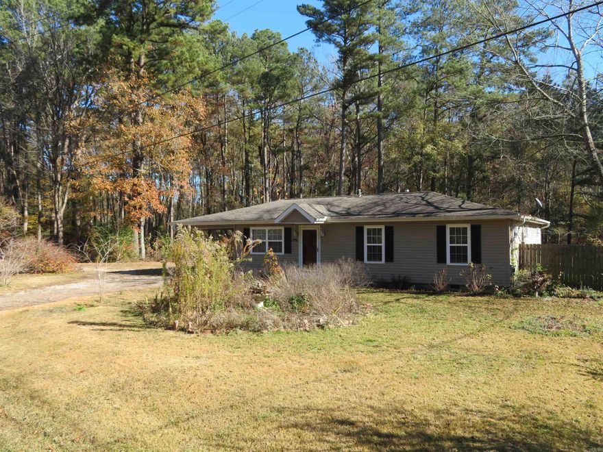 REDUCED $5,000.! Originally $174,750. NOW, $169,750.! Two BEAUTIFUL BATHROOMS, an UPDATED KITCHEN, and a 16' x 18' rear SCREENED PORCH that adds an additional, approx. 288 SQ. FT. of outdoor living area --- in the Spring, Summer, & Fall months. 'LIVING LARGE' with under 1,500 SQ. FT. heated/cooled! BIG and 'OPEN' living/dining.  Three exterior doors in living/dining and adjacent/adjoining kitchen area:  Front entry door, side carport door, and rear 'screened porch' door. Two large windows and two smaller windows are ALSO in this spacious living/dining and adjoining kitchen area. The kitchen is very ATTRACTIVE!  It features 'Travertine-style porcelain tile, a custom PANTRY CABINET, a big PRETTY island/peninsula cabinet (additional counter space!).  Energy-saving, WOOD BURNING STOVE in Dining/Living area.  LAUNDRY AREA is in big, HALL BATH.  This residence features 4 REAL BEDROOMS.  Please note:  You do have to walk through BR#3 to access BR#4. COME & SEE THE FLOOR PLAN! Awesome SECOND BATHROOM! Detached exterior STORAGE BUILDING (frame) 12' x 16'.  Can be used as a 'shop'.  This structure has a plywood floor. There is also a 6' x 12' covered shed on rear of this storage building.