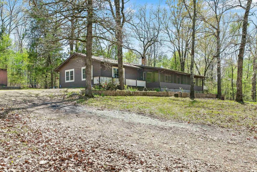 Are you looking for a quiet and peaceful place to live? This might be it.  A log siding home, 1620 sq ft with a 400 sq ft screen enclosed porch on 3+/- acres.  CH&A.  Built in 1985.  Wood deck walkway around side and back of house.  Huge living room with sewing closet. 2 Bedrooms and 1.5 Bath.  Lots of storage in bathroom and laundry room too. Nice kitchen with updated appliances.  Energy efficient windows and newly installed insulation in roof and duct work sealed.  576 sq ft metal shop with 12x24 lean-to. All this sits upon a hill overlooking your own fishpond.  Several area lakes nearby.
