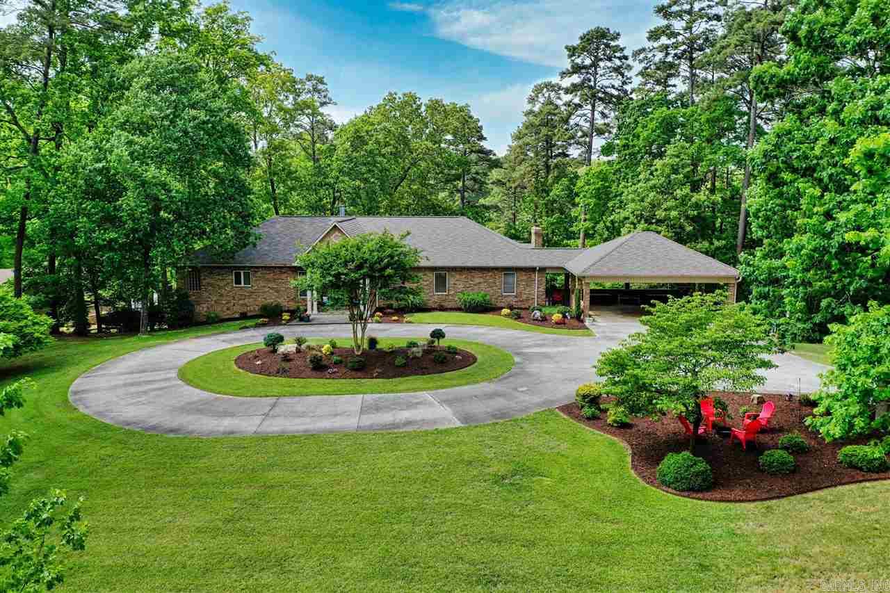 216 Scott Forge Rd is a custom designed Lake Hamilton home on 1.66 acres overlooking the Little Mazarn, available for the first time! Designed for luxurious and low-maintenance living, you'll have room for family and guests. Master suite with spa bath and private screened porch. Adjacent study could be a fourth bedroom. The chef's kitchen with Electrolux appliances opens onto a covered veranda with fireplace. Huge mudroom with extensive storage. Downstairs are a family room with 2 guest rooms and workshop.
