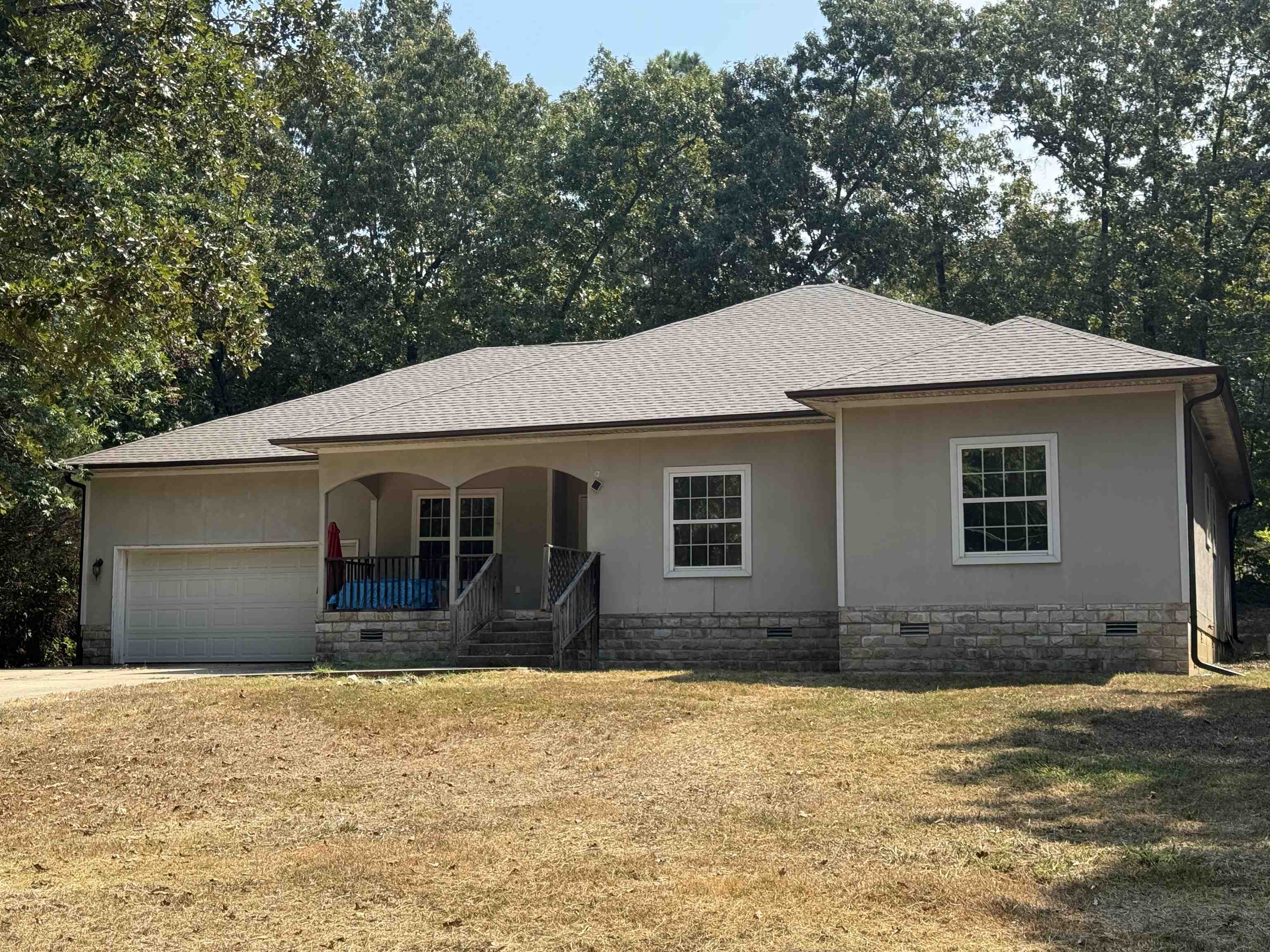 NEW ROOF Aug 2025! This charming three-bedroom, two-bath home is ideally located less than a mile from the main entrance of Cherokee Village. Built in 2007, it sits on a private, wooded lot, offering peace and privacy while remaining conveniently close to town. The home features a concrete driveway, a one-car garage with interior access, and two inviting covered porchesāperfect for enjoying the natural surroundings. Inside, youāll find new vinyl flooring throughout most of the home, with tile in the kitchen and main bathroom. High ceilings add to the spacious, open feel of the living areas. The primary bedroom includes a walk-in closet and a large bathroom complete with a jetted tub and a beautifully tiled walk-in shower. The hall bath features a standard tub/shower combo for added convenience. While the Trane HVAC unit is currently not operational, this 18-year-old home has solid bones and great potential. With a little TLC, it could be a wonderful full-time residence or a relaxing retreat in the heart of Cherokee Village.