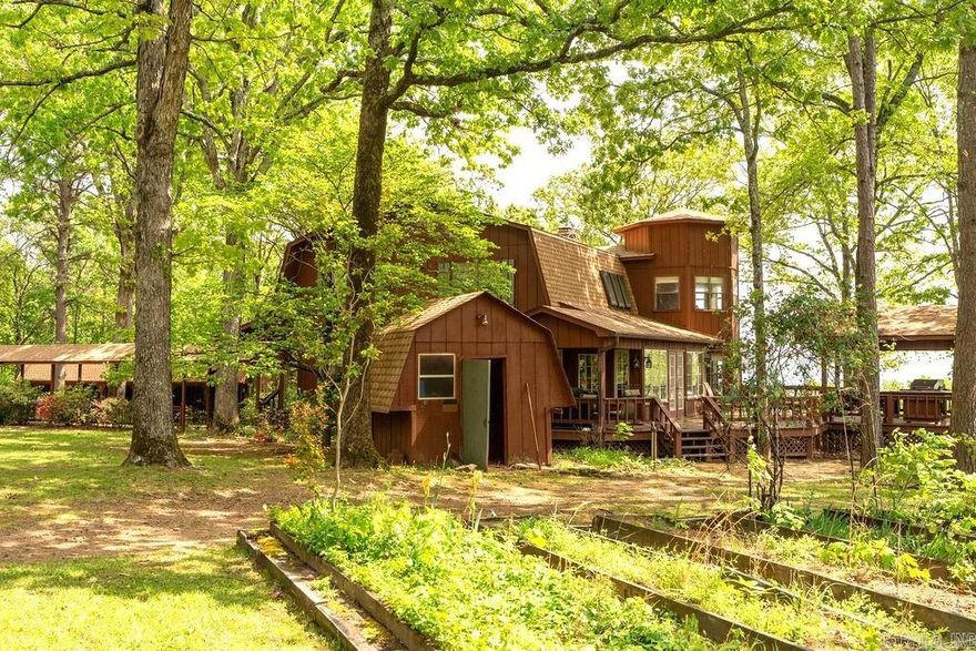 This beautiful lake view home has room for horses, a rare combination! Spacious partially covered porches and decks from which to enjoy the views and watch horses or wildlife make this home a nature lovers dream. There is also a covered grilling/cooking area attached to the deck. The open floor plan allows you to ejoy the views and the fireplace from the kitchen as well as the living room.The main house has 3 bedrooms, a sunroom and an office space with panormic views. There are 2 bedrooms in the apartment above the garage. There is a six bay equipment shed to store boats, tractor, ATVs etc. Bounded on two sides by Chreokee Wildlife Management Area, the property offers abundant wildlife viewing or hunuting. The pasture has a small pond to water your horse.