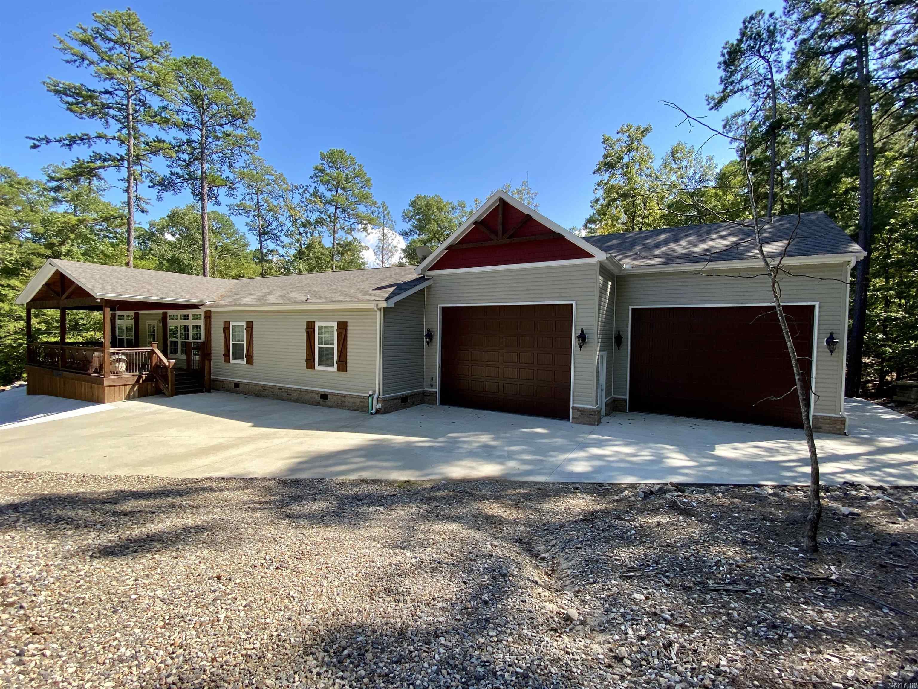 Now available in the Harbor South neighborhood at Mountain Harbor! This nicely laid out mobile home has everything you need to start spending your free time on Lake Ouachita! 3 bedrooms, 2 baths, 2,050 sq ft, open living/dining area, furnished and ready to go. The attached 1,460 sq ft, heated & cooled garage will store all your necessary lake toys so no running to dry storage! The covered back deck has a vaulted ceiling, and the outdoor cooking area & fire pit are just steps away for easy entertaining. All this sits on .43 acres +/-. Start the fall season off right by enjoying your very own lake place! Don't wait, call today!