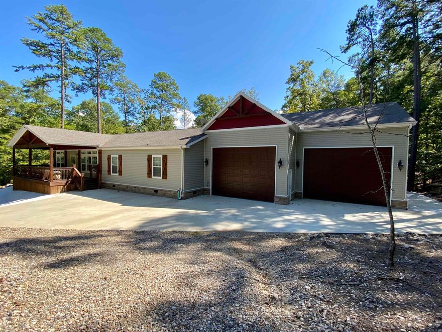 Now available in the Harbor South neighborhood at Mountain Harbor! This nicely laid out mobile home has everything you need to start spending your free time on Lake Ouachita! 3 bedrooms, 2 baths, 2,050 sq ft, open living/dining area, furnished and ready to go. The attached 1,460 sq ft, heated & cooled garage will store all your necessary lake toys so no running to dry storage!  The covered back deck has a vaulted ceiling, and the outdoor cooking area & fire pit are just steps away for easy entertaining.  All this sits on .43 acres +/-.  Start the fall season off right by enjoying your very own lake place!   Don't wait, call today!