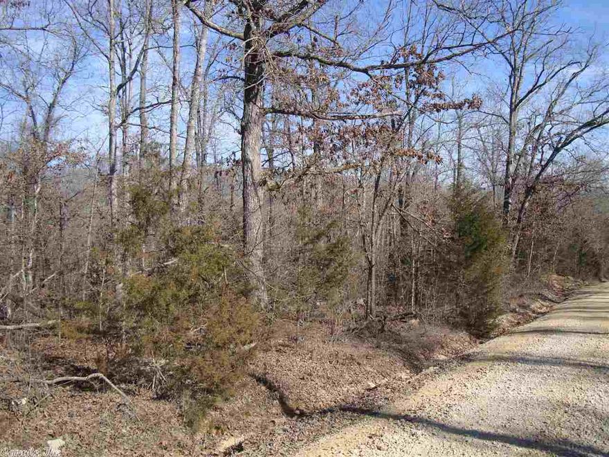 Utilities available on property, property is wooded and sets on a gravel road. Semi private with a slight slope to back of property.