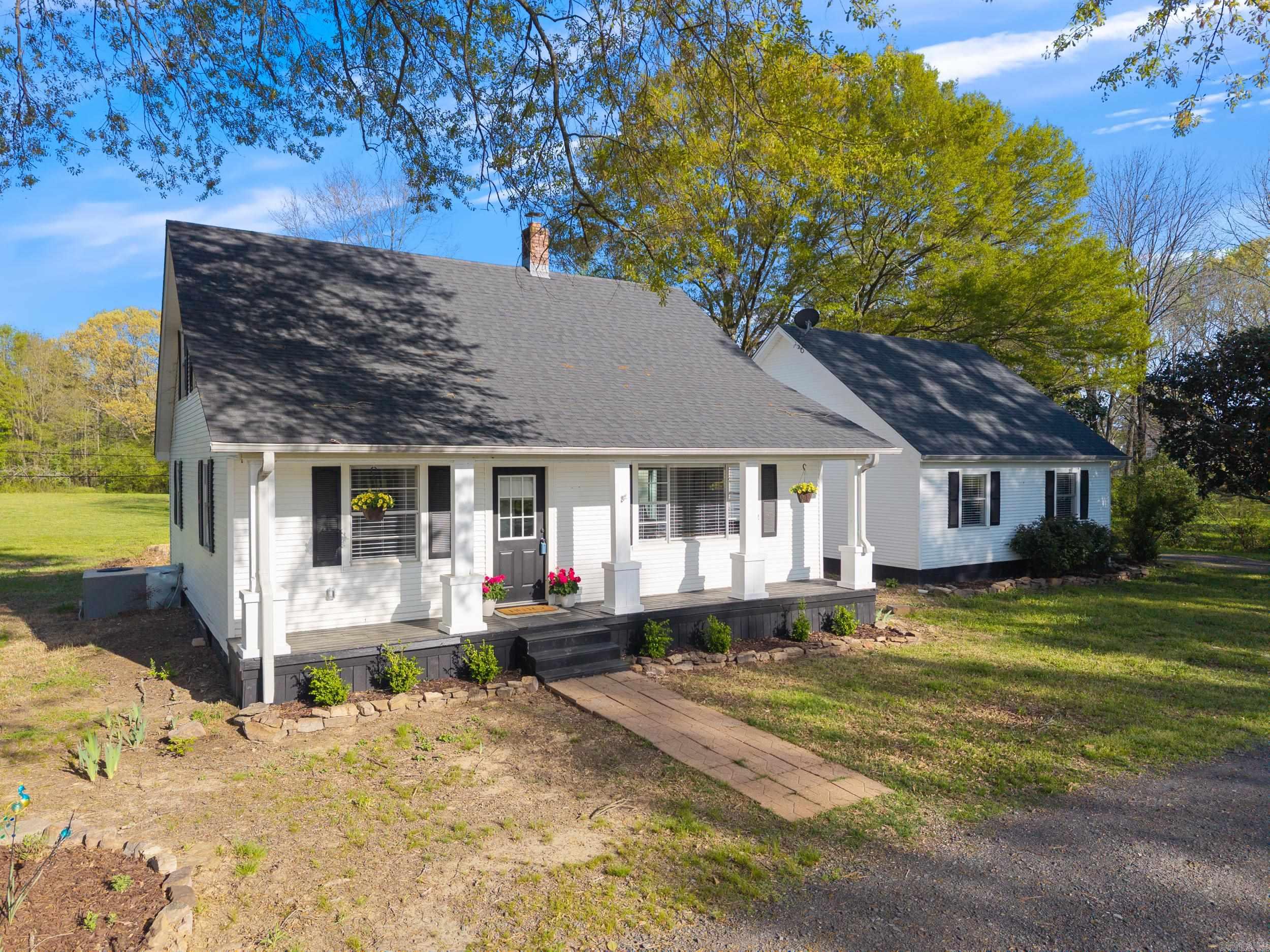 This beautifully remodeled farmhouse offers 4 bedrooms, 2 bathrooms, and a spacious bonus room, perfect for a home office, playroom, or an extra bedroom. Nestled on just over 5 acres of peaceful countryside, the property features a true 2-car garage with additional storage space and a convenient circle driveway. Move in ready + refrigerator, washer, & dryer to stay! Enjoy the outdoors with a 6-stall barn, ideal for livestock or hobbies, and plenty of gardening space. Additionally, the property is equipped with RV hookups - perfect for hosting family & friends for an extended stay! Located only 7 minutes from Cabot public schools with no livestock restrictions, this home provides the perfect blend of country living with easy access to town! With renovations complete & new HVAC, hot water heater, roof, appliances, & more, this home offers comfort + peace of mind!