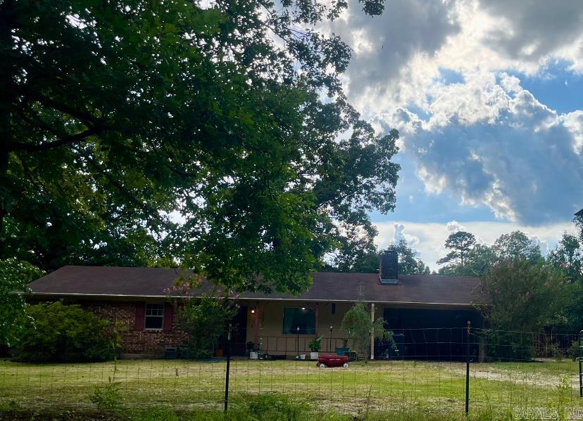Welcome to 7821 Rawls Circle — a charming 3-bedroom, 2-bath home set on 3 acres in a peaceful country setting on the outskirts of Pine Bluff. Located in the Watson Chapel School District, this property offers the perfect combination of privacy, space, and convenience. Inside, the home features rustic wood-paneled walls, updated wood-look flooring, and a cozy Schrader fireplace that adds warmth and character to the living area. Enjoy meals in the bright dining area with a large window that lets in natural light and overlook the serene property. There’s plenty of room for gardening, recreation, or simply relaxing in your own private retreat. Whether you’re looking for a homestead feel or room to grow, this property is full of charm, function, and possibility — all with the peace of country living just minutes from town.