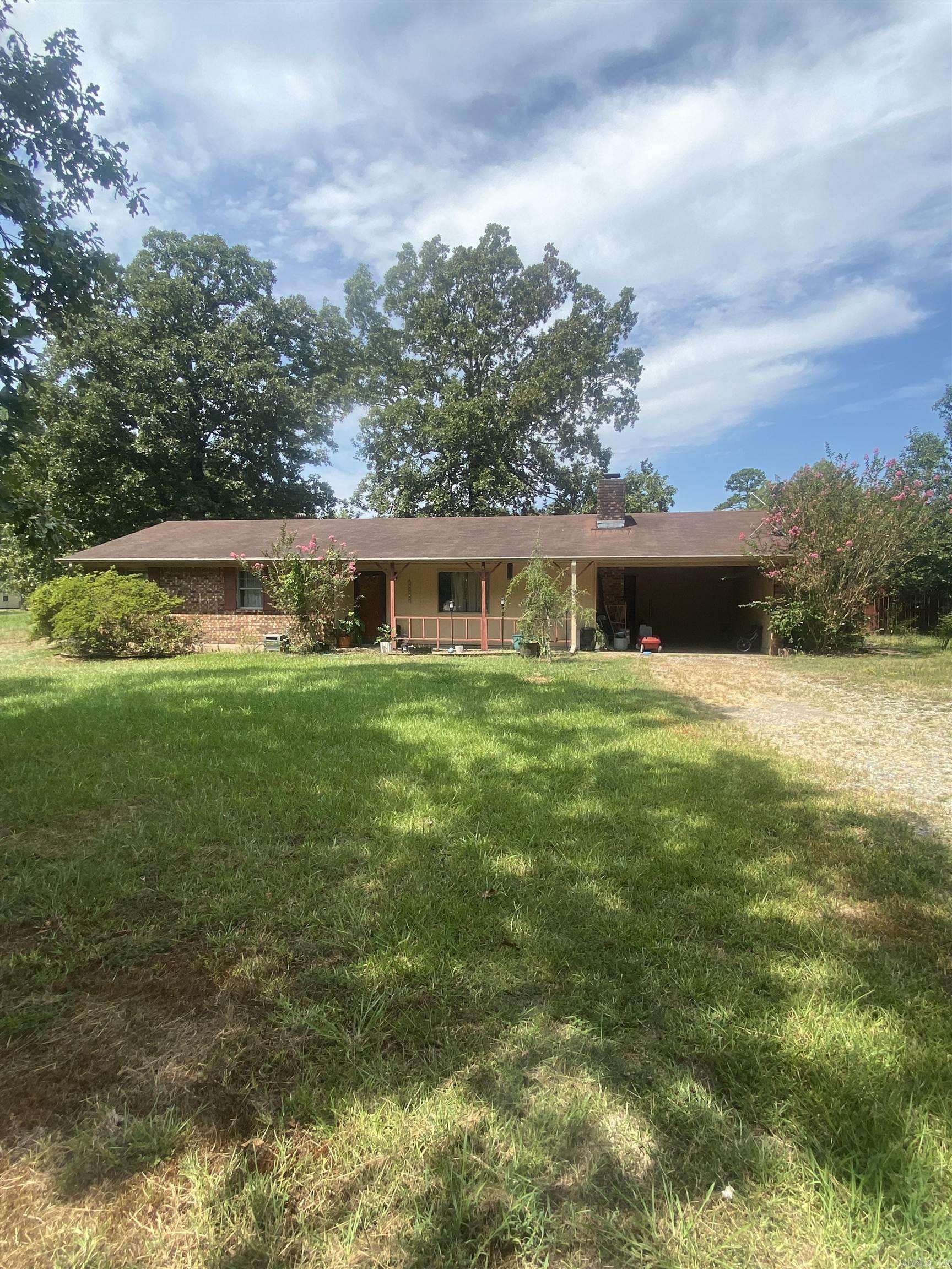 Welcome to 7821 Rawls Circle — a charming 3-bedroom, 2-bath home set on 3 acres in a peaceful country setting on the outskirts of Pine Bluff. Located in the Watson Chapel School District, this property offers the perfect combination of privacy, space, and convenience. Inside, the home features rustic wood-paneled walls and a cozy fireplace that adds warmth and character to the living area. Enjoy meals in the bright dining area with a large window that lets in natural light and overlook the serene property. There’s plenty of room for gardening, recreation, or simply relaxing in your own private retreat. Whether you’re looking for a homestead feel or room to grow, this property is full of charm, function, and possibility — all with the peace of country living just minutes from town.