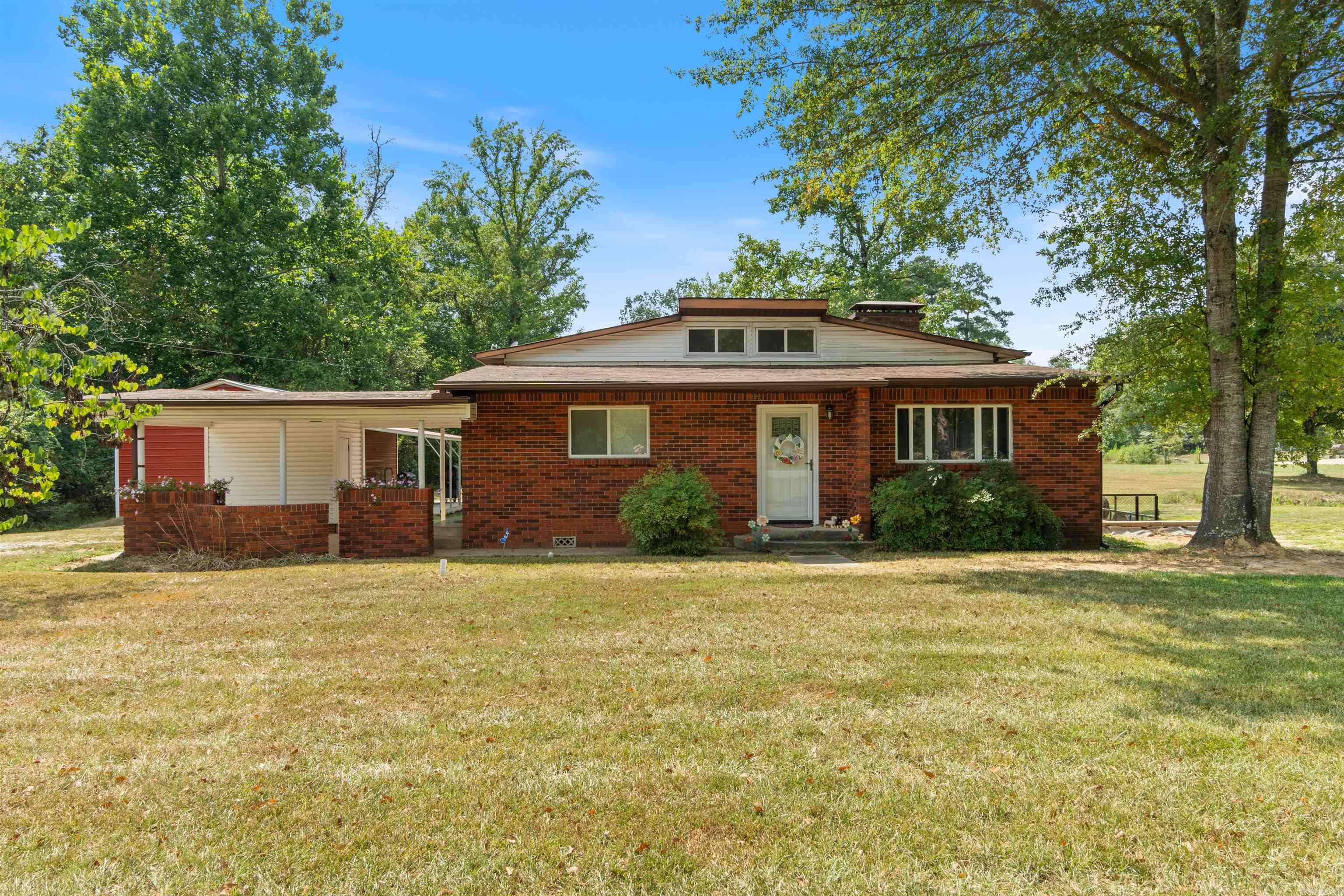 Come take a look at this picturesque home in rural Bauxite. It's set on almost 2 and a quarter acres with a shop, electrical for an RV, storm shelter, pond and a peaceful view! It's also eligible for Rural Development - so if you qualify for a USDA loan, then you would have no down payment. This home has been updated with a new stainless electric range, stainless microwave, new paint and granite countertops. Tons of updates have been done outside with the terrain: new retaining wall, back and side yard regrading, track drain, sump pump and the inlet to the pond has even been cleaned up. These sellers have meticulously cared for everything they can to make sure that the new owner is all set for years to come!