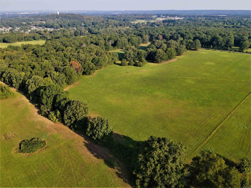 - 70 +/- total acres  - Wet weather creek - Electricity, fiber and water on the property - Mature mixed timber with numerous oaks - 25 +/- acres of timber/ 55 +/- acres of pasture - Mostly level topography - Multiple ponds - Paved road frontage - Mostly perimeter fenced - Can be split 40/30 +/- acres -  3.8 miles to I40/Lewis Crossing -  3.8 miles to I40/Oak Street