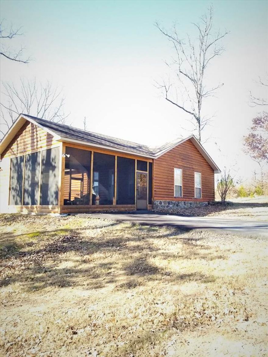 Near Lake Cabin on approx 1 acre of land.This freshly repainted 2 bed 1 bath cabin boosts nearly 1200 sqft of living space.It sits approx 1 mile from Smith Hill Creek Marina and Recreations Park.  If you want to live at the lake but are not ready to pay living on the lake prices then this is your (near) Lake Home! Vaulted Ceilings,large living room, an AMAZING Screen in Porch combines nicely with the outdoor gas fireplace making any night a relaxing one.Whether inside or out You can enjoy every season here!