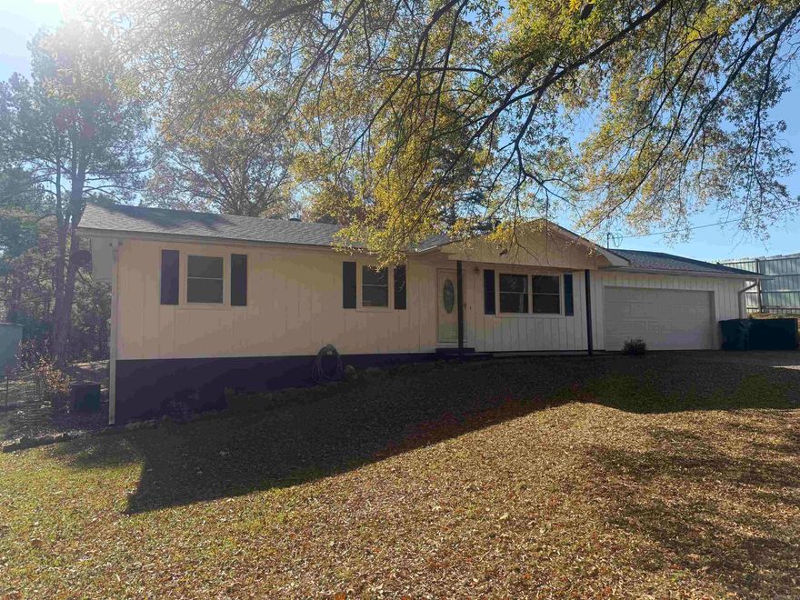 Discover peaceful living just outside the city limits with this beautifully maintained 3-bed, 2-bath home offering 1,228 sq ft of comfort on just under an acre. Built in 1985, this property blends charm, space, and practicality—complete with a versatile shop perfect for projects, storage, or hobbies. Inside, you’ll find a warm and inviting layout with natural light, functional living areas, and room to make it your own. The expansive yard provides privacy and plenty of space for gardening, outdoor gatherings, or simply enjoying the quiet surroundings. Located minutes from Hot Springs, you’ll enjoy easy access to world-class amenities including Hot Springs National Park, scenic hiking trails, lakes for boating and fishing, Oaklawn Racing & Gaming, vibrant dining, and local boutiques. This home offers more than a place to live—it’s a lifestyle of relaxation, recreation, and room to grow. Whether you seek a peaceful retreat or a property with space to spread out, this one has it all.
