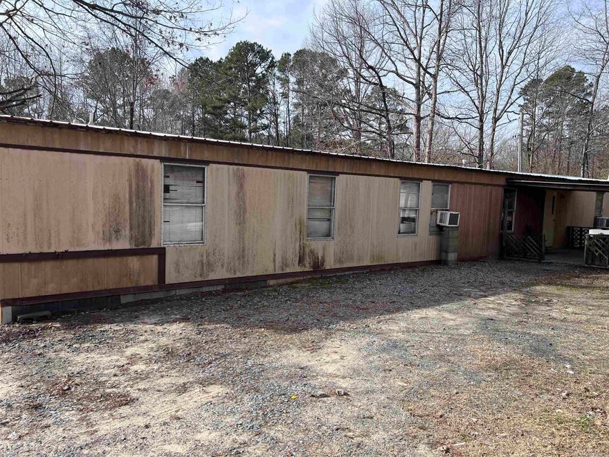 Great opportunity to own acreage featuring a small spring-fed pond, cleared land, and tons of potential! This property includes a 2 bedroom, 2 bathroom mobile home that needs a little TLC but could technically be move-in ready. Priced to reflect AS IS, giving you the chance to add your own updates and value.  The property already has the perfect homesite from a previous residence, complete with separate water and electric hookups, plus an additional septic hookup — ideal for a second home, guest house, rental, or future build.  Enjoy a long private driveway leading you back off the road, offering peace, privacy, and plenty of room for animals, a garden, or simply wide-open space. A huge shop/shed provides excellent storage, workspace, or hobby area.  Whether you’re looking for a homestead setup, investment opportunity, or a place to build your dream home, this one checks all the boxes. Opportunity is knocking!