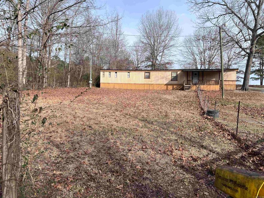 Great opportunity to own acreage featuring a small spring-fed pond, cleared land, and tons of potential! This property includes a 2 bedroom, 2 bathroom mobile home that needs a little TLC but could technically be move-in ready. Priced to reflect AS IS, giving you the chance to add your own updates and value.  The property already has the perfect homesite from a previous residence, complete with separate water and electric hookups, plus an additional septic hookup — ideal for a second home, guest house, rental, or future build.  Enjoy a long private driveway leading you back off the road, offering peace, privacy, and plenty of room for animals, a garden, or simply wide-open space. A huge shop/shed provides excellent storage, workspace, or hobby area.  Whether you’re looking for a homestead setup, investment opportunity, or a place to build your dream home, this one checks all the boxes. Opportunity is knocking!