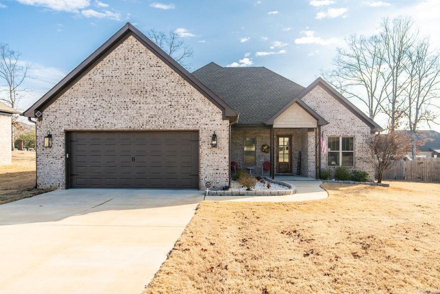 You want to see this home!  Stepping through the front door you are met with a lovely open floor plan, a warm inviting fireplace, and regal wood floors!  To your right, you will find a hallway leading to two additional bedrooms and a full bathroom.  Leaving the hallway you enter the living room that opens directly to kitchen and dining space.  Enjoy the convenience of the open concept as you mingle through all of these spaces!  Just off the dining space, you find the door to the screened in porch and extensive deck space perfect for enjoying your landscaped backyard!  Once back inside, you will enjoy the privacy of the primary suite sitting away from the additional bedrooms.  The oversize primary bedroom also has a private ensuite with walk in shower, water closet, spa soaking tub, and walk in closet.  Upon entering the home through the garage you will love the convenient mudroom space that leads to the separate laundry room.  Call listing agent for more details and schedule your showing today!  Agents, please make sure to read the confidential remarks regarding pets.