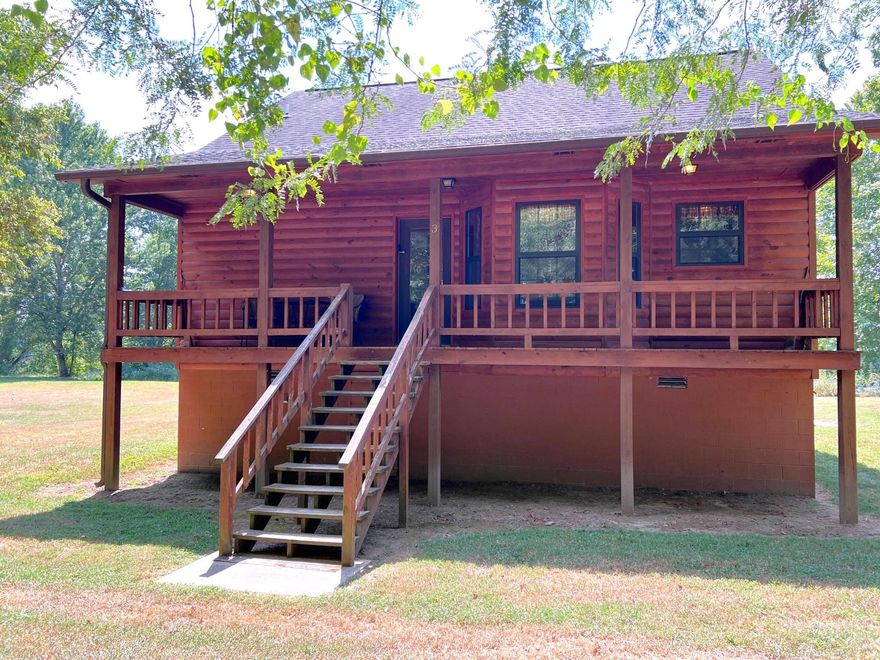 Nestled along the banks of the White River and tucked below the historic bluffs that give Calico Rock its name, this 1,422 sq. ft. riverfront cabin is a rare find. Gated access and a hidden road lead to unmatched privacy, where rustic charm and modern comforts combine.  The home offers 1 bedroom, 2 full baths, and a spacious loft that could easily be converted into a second bedroom. Warm wood accents, an open floor plan, and wide windows frame breathtaking river views. Outside, the covered porch is the perfect place to sip your morning coffee while watching the White River flow—famous for world-class trout fishing and natural beauty.  Set on a level, half-acre lot with direct river frontage, this turnkey property is move-in ready. With central heat and air, a fully equipped kitchen, washer/dryer, and ample parking, it’s ideal as a private retreat, full-time residence, or vacation property with excellent investment potential.  Experience riverfront serenity below the bluffs of Calico Rock—shown by appointment only.