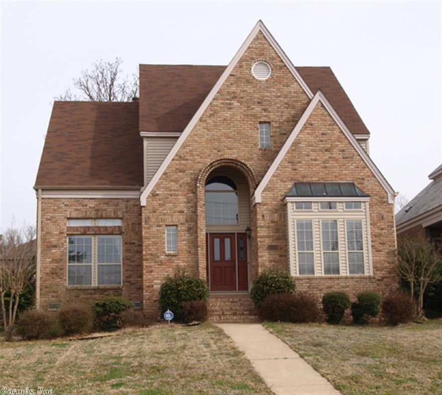 Lovely brick w/vinyl 2 story entrance with tremendous street appeal! Hardwood flooring on the main level w/library paneling and woodburning fp. Kitchen features a pass thru w/wet bar and breakfast area. Formal dining off the kitchen. Transoms along the ceiling provide for tremendous natural lighting as well as the 2 story entry! Master BR on main level, upstairs 2 BR's and a general use loft area!  Walk in storage area on 2nd level could be finished into a game room or man-cave.