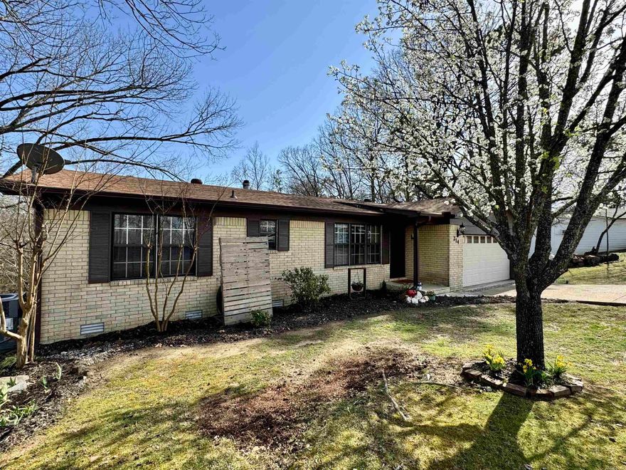 Welcome to this beautifully updated 5-bedroom, 3-bathroom home that offers a perfect balance of space, comfort, and modern convenience. The heart of the home is the stunning, renovated kitchen. Featuring elegant granite countertops, ample cabinet space, and sleek stainless steel appliances, this kitchen is perfect for preparing meals and entertaining guests. The open design flows seamlessly into the living and dining areas. Upstairs, you'll find two generously sized bedrooms. Downstairs, three additional bedrooms provide ample space for family members or guests, with a convenient bathroom just steps away. All bedrooms in the home have been updated with fresh, new carpet.  New roof, garage door and opener, leaf guard gutters and water heater. Step outside to enjoy the peaceful deck off the back of the home, perfect for relaxing or hosting BBQs in the warmer months and is an ideal spot to unwind after a busy day.  A 2-car garage offers plenty of storage and parking. Located in a desirable neighborhood, this home is close to schools, parks, shopping, and dining. Oh I didn't mention it has deeded Lake Hamilton access!