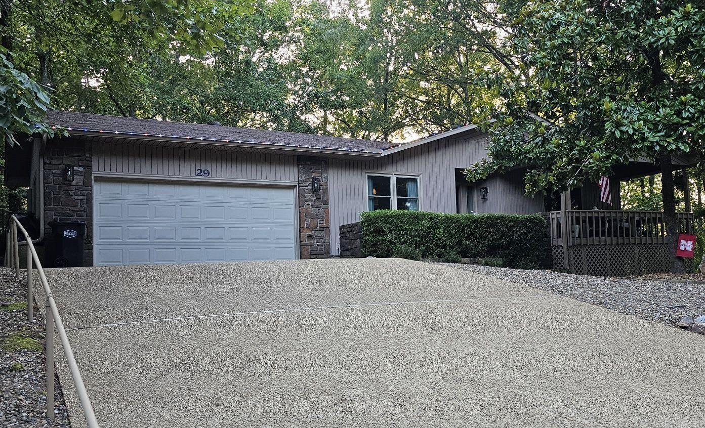 **MUST SEE!** Conveniently located just minutes from the amenities outside the West gate, this beautifully updated home offers an abundance of privacy. It features three decks, three bathrooms, two living rooms, and a two-car garage with a new professional epoxy floor. Recent updates include brand new Pella windows and sliding glass doors, new flooring, new solid interior doors, custom drapes, and an updated kitchen with stainless steel appliances, a stone backsplash, new sink, faucet, disposal, and quartz countertops in both the kitchen and bathrooms. Additionally, there are new lighting fixtures throughout, a remodeled primary bathroom, and much more! The third bedroom and bathroom downstairs can serve as a potential mother-in-law suite, office, or boomerang child's quarters. The home boasts gorgeous built-ins throughout. With a newer roof, HVAC systems, and a crawl space that was encapsulated in 2021, this home is a must-see! Don’t miss out; come see this beautiful property today! **See Agent Remarks.**