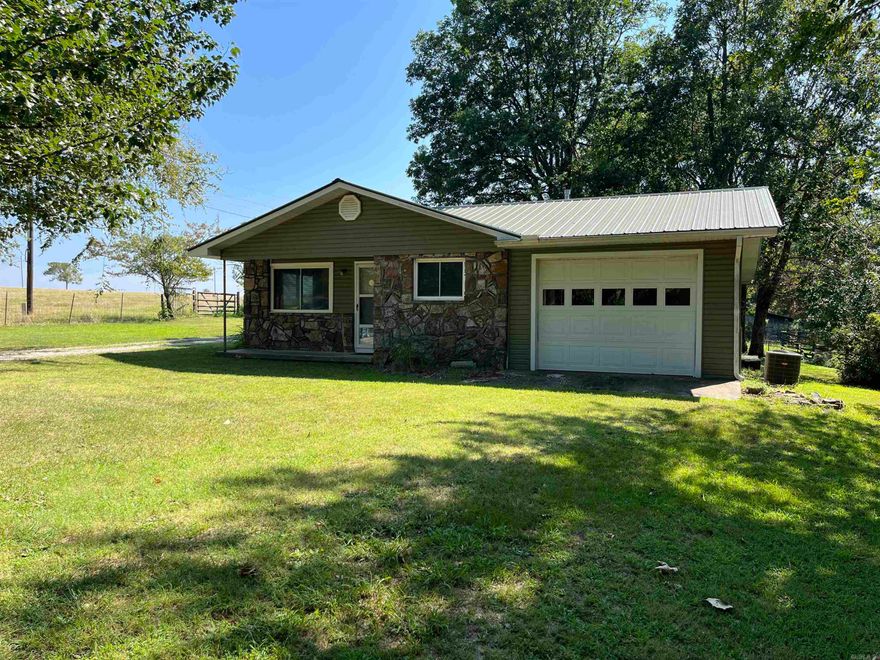 If you are looking for the peace and tranquility of rural living, take a look at this country home with frontage on Hwy 66 between Leslie and Mountain View, AR. This is a great location near the pristine Buffalo National River with outdoor activities including kayaking/canoeing, hiking and camping. Mountain View is just a few miles east on Hwy 66 with more entertainment at the Ozark Folk Center and music on the square.  This 1,002 sq ft 2 bed/1 and 1/2 bath country home has native stone and vinyl siding exterior. This older home has recently had some updates to include central heat/air, fairly new roof and windows. Fairly new stove and refrigerator to convey. Some renovations started will need to be completed. The back porch has been enclosed for additional living space. New PEX line.There is a 1 car garage as well as a 1 car carport on the back of the house. This acreage has large shade trees with a park-like setting. For the gardener, there is a designated garden spot. A nice shop with concrete floor and electricity with a fenced in area is out back. There is an old well but the home is currently serviced by rural water. in ground termite system. New survey. SOLD AS IS, WHERE IS.