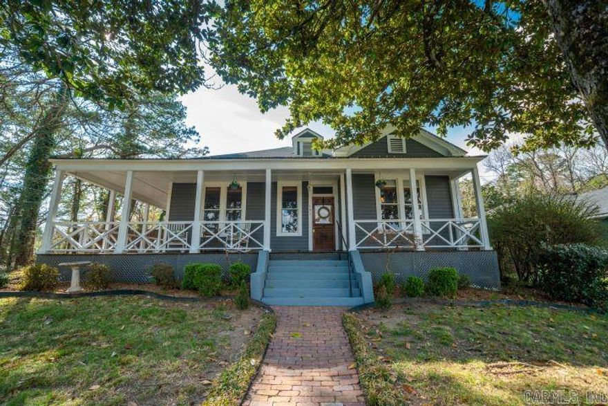 Step into the perfect blend of historic charm and modern farmhouse style in this beautiful 3-bedroom, 1-bath cottage built in 1939. Located just minutes from Northwoods Trail and downtown Bathhouse Row, this home offers character, comfort, and incredible potential.  The inviting enormous front porch welcomes you with classic cottage charm—perfect for morning coffee, relaxing evenings, or gathering with friends and family. Inside, you’ll find updated finishes and a light, airy farmhouse aesthetic that complements the home’s original character.  The home features three comfortable bedrooms and one full bathroom, with excellent potential to add a second bathroom in the laundry room, creating additional convenience and value. Step outside to enjoy a good-size backyard perfect for evening gatherings, relaxing under the stars, or weekend cookouts. A storage building provides extra space for tools, outdoor gear, or hobbies. The rear lot offers valuable off-street parking and added flexibility rarely found this close to downtown.   This charming cottage is ideal as a full-time residence, weekend getaway, or investment opportunity in one of Hot Springs downtown areas.