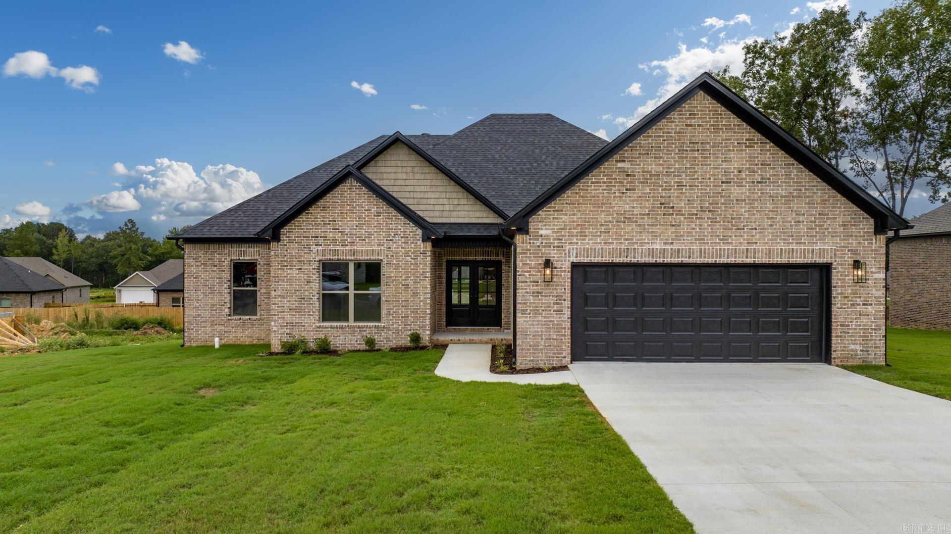 Looking for a beautiful new home on over a half acre, but still just minutes from town? Look no further, we've got you covered! This 4 bed, 2 bath open floor plan home boasts 10 and 11 foot ceilings in main area, over sized cabinets in the kitchen, and custom beams and trim work throughout! The primary suite has a HUGE custom tile shower with frameless glass, double vanity, stand alone soaker tub, all connecting to the laundry room for ultimate convenience! Guest side bedrooms are large with large closets. Flooring will be tile in bathrooms and laundry and Next Gen waterproof WOOD floors in the remainder of the house! Natural gas heat, fireplace, and range! Oversized driveway for extra parking! All of this sitting on over a half acre in an established subdivision literally 2 minutes from town! Call your favorite agent to schedule your showing before it is too late! Construction still in progress, any photos are of the same floor plan to show layout but finishes will be different.  Estimated completion before Christmas! Spend Christmas with your family in this beautiful home!