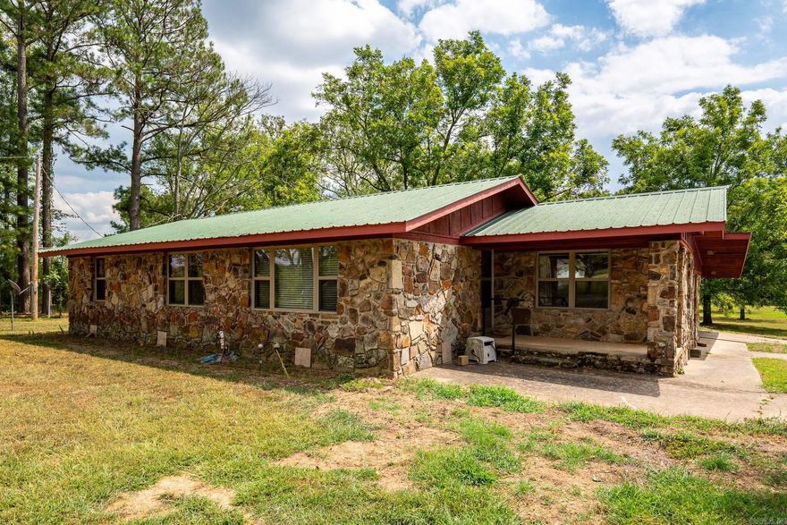 Welcome to this charming rock farmhouse located within a 10-minute drive from Greenbrier, Vilonia, and Conway. Built in the 1960s, this home has character and offers a wonderful opportunity for a homestead/country lifestyle. If you happen to love green shag carpet, you're in luck!  While some updates might be on your to-do list,the home HAS undergone a pre inspection.  The HVAC and front windows are only a few years old and the home was just re-insulated.  This property goes beyond the home itself, offering several outbuildings, pecan trees, and a wired 20x30 shop. City water lines located on the property.   An extra 30 acres of land is available, presenting the chance to turn your vision of a larger homestead, farm, or potential investment into a reality.