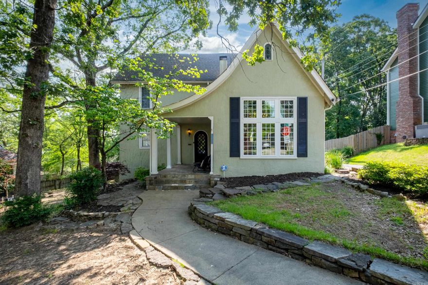 Welcome home to Hillcrest. With its quiet location north of Hill Rd, this charming home greets you with a front porch and a gorgeous custom door. As you step through the foyer into the living room, soaring barrel and stained wood beam ceilings and a gorgeous fireplace bring a flare of Spanish Revival style. Oversized windows create abundant natural light while hardwood floors add warmth and rich wood tones. The dining room flows effortlessly from the living room, the kitchen, and the spacious den which also has plenty of space for adding more casual dining. The back deck has plenty of space for entertaining family and friends and enjoying the outdoors. The lower patio is the perfect place for a BBQ and watching the game (plumbed and ready for you to add an outdoor kitchen).  2 car side entry garage plus parking pads for additional off-street parking. The adjacent lot is available for $199,000.