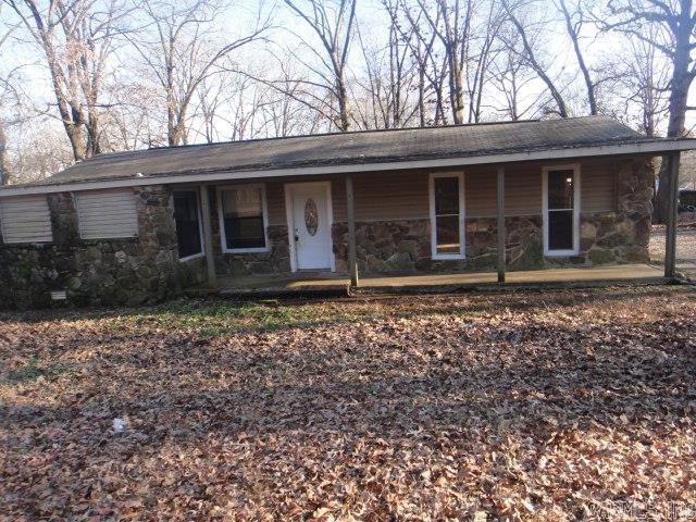 This cozy rock house, situated at the end of Kari Road, sits on 1 acre. It has a storage building. In the house is one large bedroom with a fireplace and one smaller bedroom apart. There is a nice size awning for parking. See Agent Remarks for submitting an offer.