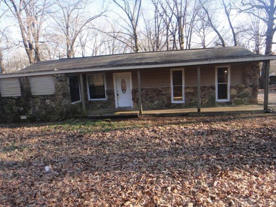 This cozy rock house, situated at the end of Kari Road, sits on 1 acre. It has a  storage building. In the house is one large bedroom with a fireplace and one smaller bedroom apart. There is a nice size awning for parking. See Agent Remarks for submitting an offer.