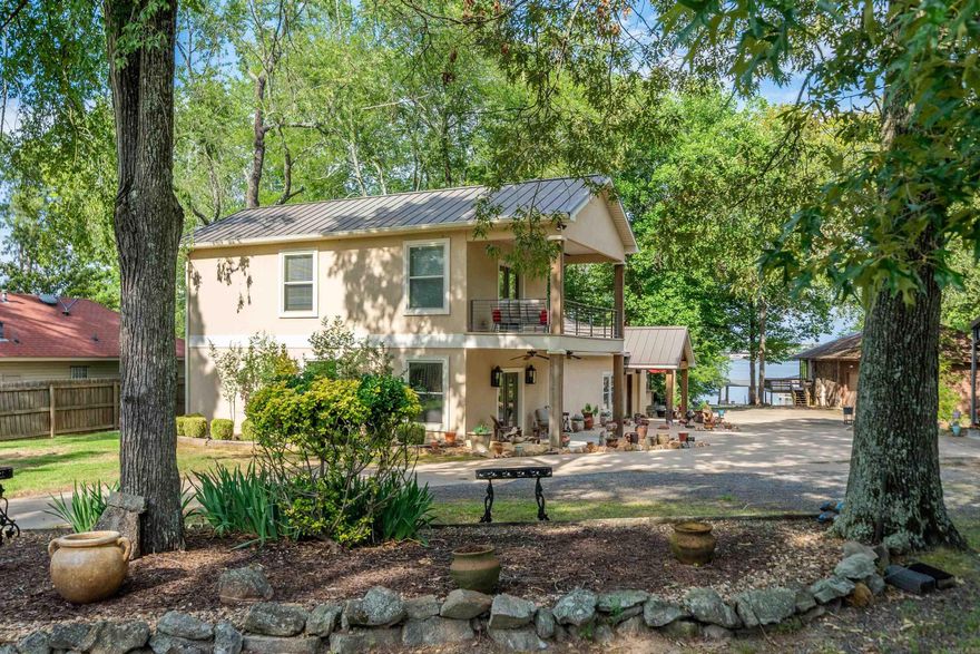 Check out this unique opportunity to own a family compound with acreage on Lake Hamilton. A covered boat dock has additional concrete boardwalks & walkways to maximize your lake fun. The large yard leading to the lake has space for yard games or the addition of a pool.  110 Spurwink was remodeled to become a 4 bedroom/4 bathroom home w/ a flex room that would be perfect as a bunk room, gaming room, craft room, etc. There are 3 massive suites to choose from as your owner's suite. 2 of the bathrooms have massive luxury walk-in showers while the other 2 have oversized tubs with shower heads. The generator ensures you will stay comfortable during any power outages. And, the metal roof adds additional peace of mind. The 2 laundry rooms will  keep chores under control. And, all bedrooms have large walk-in closets to store all of those clean clothes. 112 Spurwink is a 4 bd/2 ba home that has been partially demoed to see its potential.  Both living areas are full of windows to bring lake views front & center. There is a 2 car garage attached -- plus, an extra tall 3-car carport for parking RVs, boats, etc. The expansive 1.44 acres allows for a garden or more housing. Come take a tour!