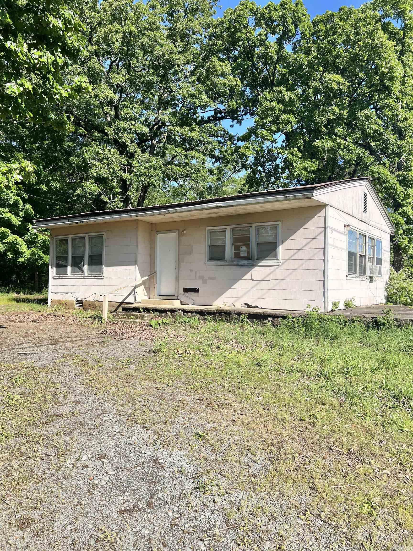 Charming 2-bedroom, 1-bath home situated on 3.01 acres right on Highway 65—offering both visibility and versatility for residential or commercial use. This property has already seen some updates and is partially remodeled, providing a great head start for a buyer with vision. With just a bit more work, it could easily be transformed into a comfortable home or a unique business location. The large screened-in porch adds valuable outdoor living space, and the expansive lot offers plenty of room to expand, garden, or develop further. A fantastic opportunity with endless potential! *See agent remarks
