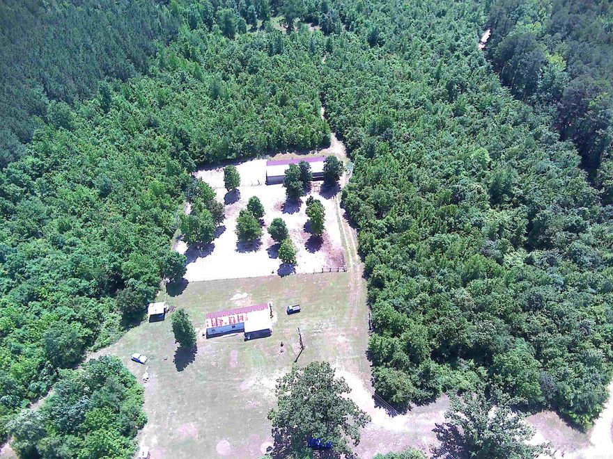 ***7.78 Acres with Mobile Home & Shop Building on Scenic Skyline Drive*** Beautiful property with multiple locations to build a new home, cabin or hunting retreat. The interior of the mobile home has been updated and is super cute and cozy with a spacious kitchen/living area. For hunters, there is a covered area with water and electricity for cleaning game as well as "shooting lanes" and multiple places for deer stands. The new 24x70 metal building has overhead doors on each side for pull through convenience and could store all of your toys and equipment. High speed fiber internet by South Central Co-op lets you stay connected while also enjoying the country life!