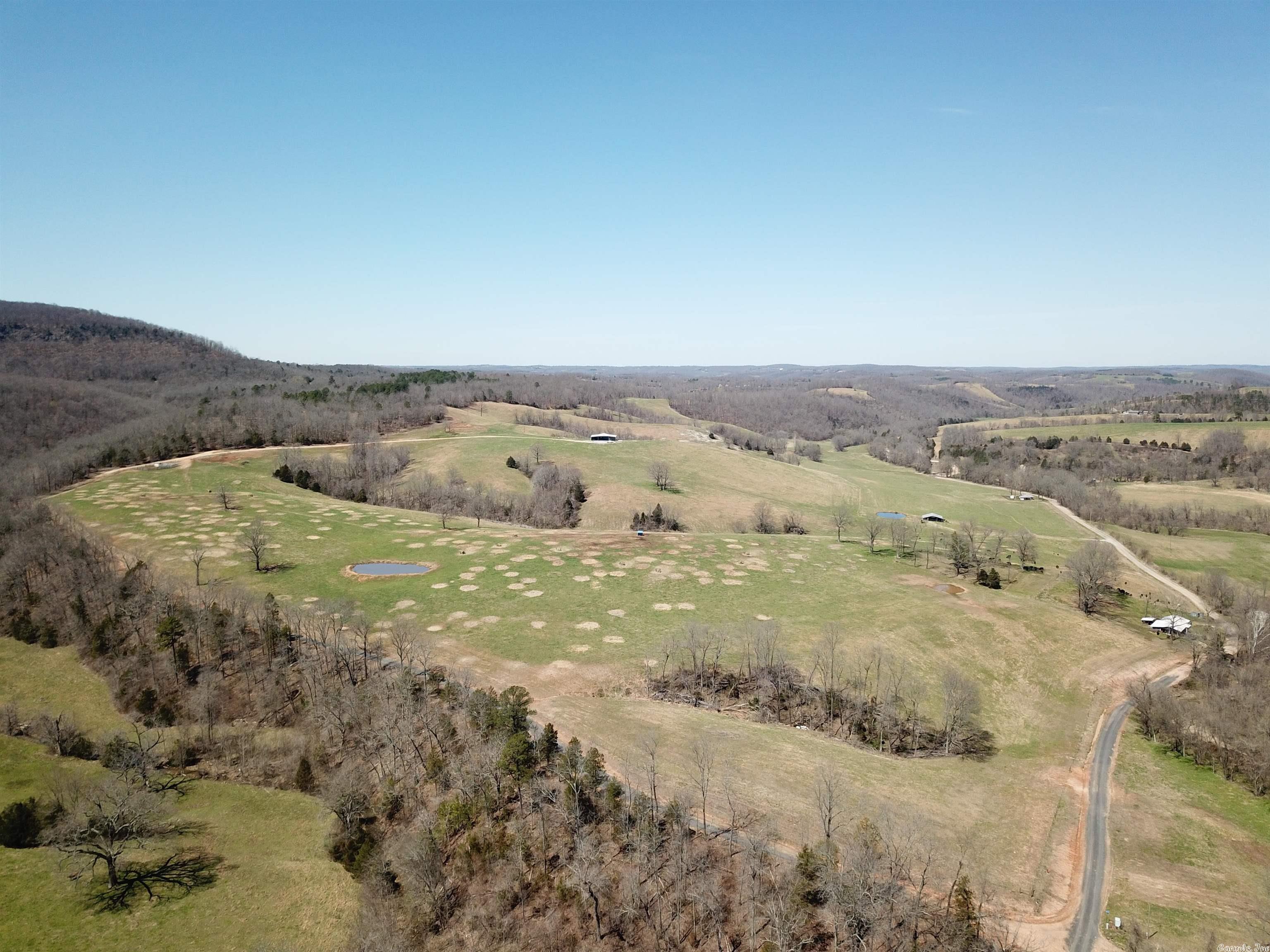 329 Acres +/- Cattle Farm, Hunting property, 3 bedrooms, 1 bath brick home, & a 2 bedroom, 1 bath barndominium. This property has a creek, city water, ponds, Spring, new fencing, pasture, gravel Searcy County road frontage, wildlife, and some of the most beautiful views I have seen. The farm has been very well manicured and the wildlife is plentiful in this area of the county.