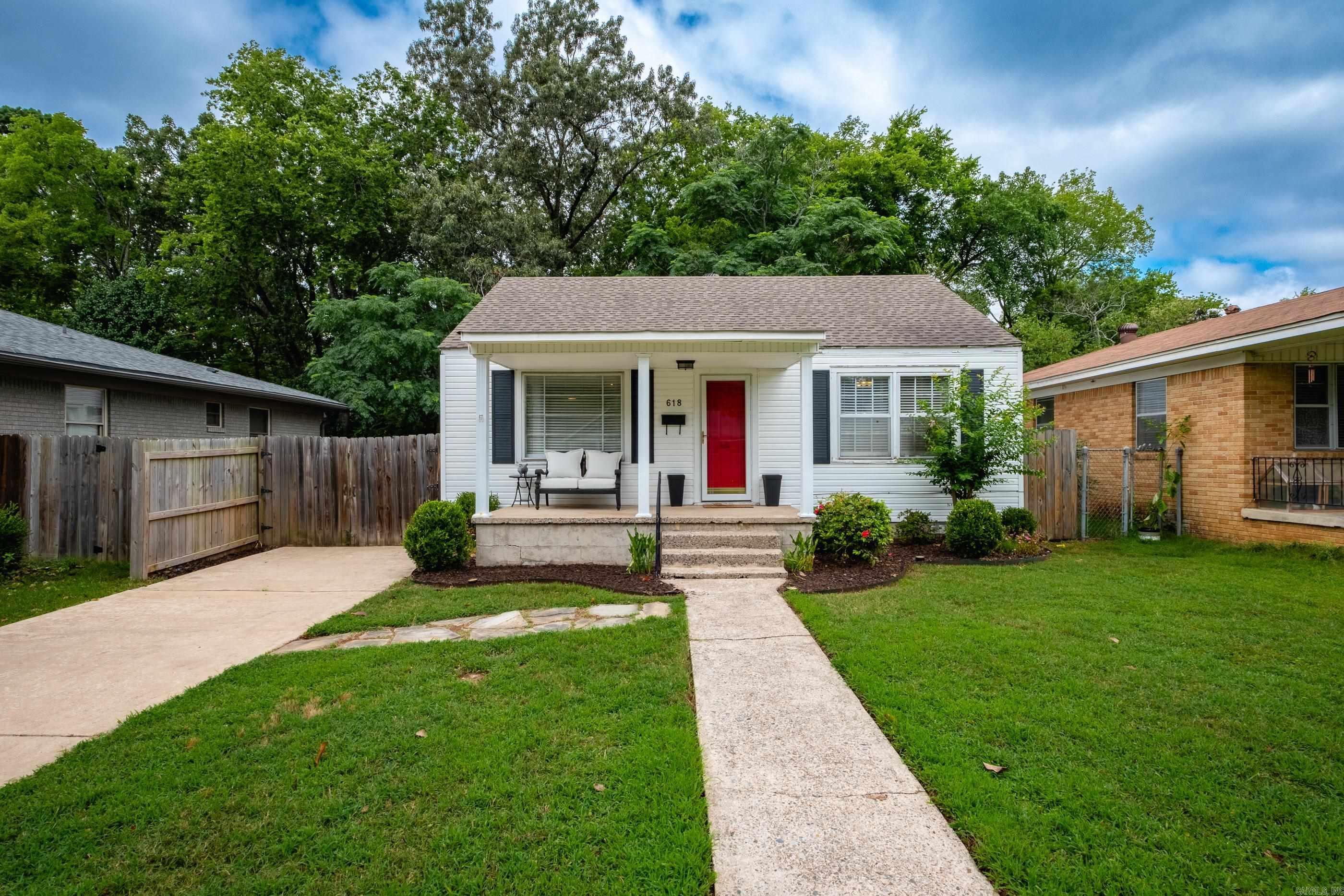 Charming 2 Bedroom Cottage with beautiful original details and modern touches. From the moment you step onto the inviting front porch, you'll feel right at home. Inside, stunning original hardwood floors and crystal door knobs add timeless character along with a layout that lives larger than expected. Updates included new bath floor, vanity, mirror and lighting, new deck and back fence. Refrigerator, washer and dryer all convey. Located just minutes from shopping, dining, and top-rated hospitals, this home offers both comfort and convenience in a desirable location.
