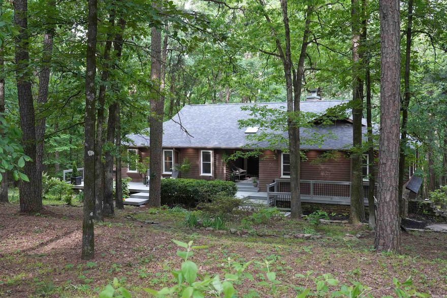 Private Retreat in the Heart of Russellville! Welcome to a rare sanctuary where comfort meets nature. This beautifully designed 4-bedroom, 3-bath home is nestled in a serene woodland setting and gold certified Bird-Friendly by the Arkansas Audubon Society—making it a true haven for wildlife lovers and those who value peace and privacy. Thoughtfully laid out with versatility in mind, this home features dedicated Mother-in-law quarters—perfect for extended family, guests, or multi-generational living. A new roof in fall of 2022, & many other updates. Large windows invite stunning wooded views and natural light, creating a warm, peaceful ambiance you will love. Although tucked away in a private, forested setting, the property offers unbeatable access to Lake Dardanelle, the State Park, schools, shopping, medical facilities, and everything downtown Russellville has to offer. It’s the perfect blend of seclusion and convenience. This home offers harmony with nature, without sacrificing modern comforts.