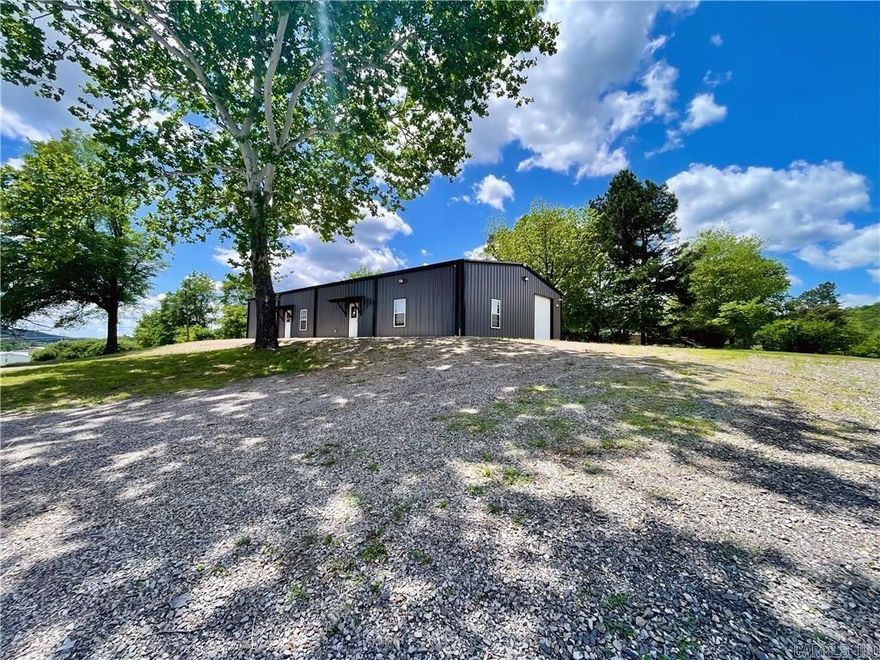 This 3200 sq ft facility is newly constructed on 1.17 acres, just a block off of Hwy 7. Custom designed and built in 2023 with focus on beauty and function. The south side of the building features a 2000 sq ft design studio/ retail space, with abundant lighting, luxury vinyl flooring, clean white walls and trim, half bath, full kitchen with dining area, social media photography room, and a 13x14 storage room. This open concept lends itself to a plethora of possibilities to customize the space to suit your needs! Just down the hall you’ll enter into a 1200 sq ft warehouse space, with a large insulated overhead door, half bath, high ceilings, 3 ton ductless heat and air unit for comfort, and 2 additional exterior doors. The state of the art security system lets you keep an eye on your space while you’re away. Beautiful green space out back, several mature trees, large gravel parking area, and a circle drive. With such a large lot, there is plenty of room to add on if needed.