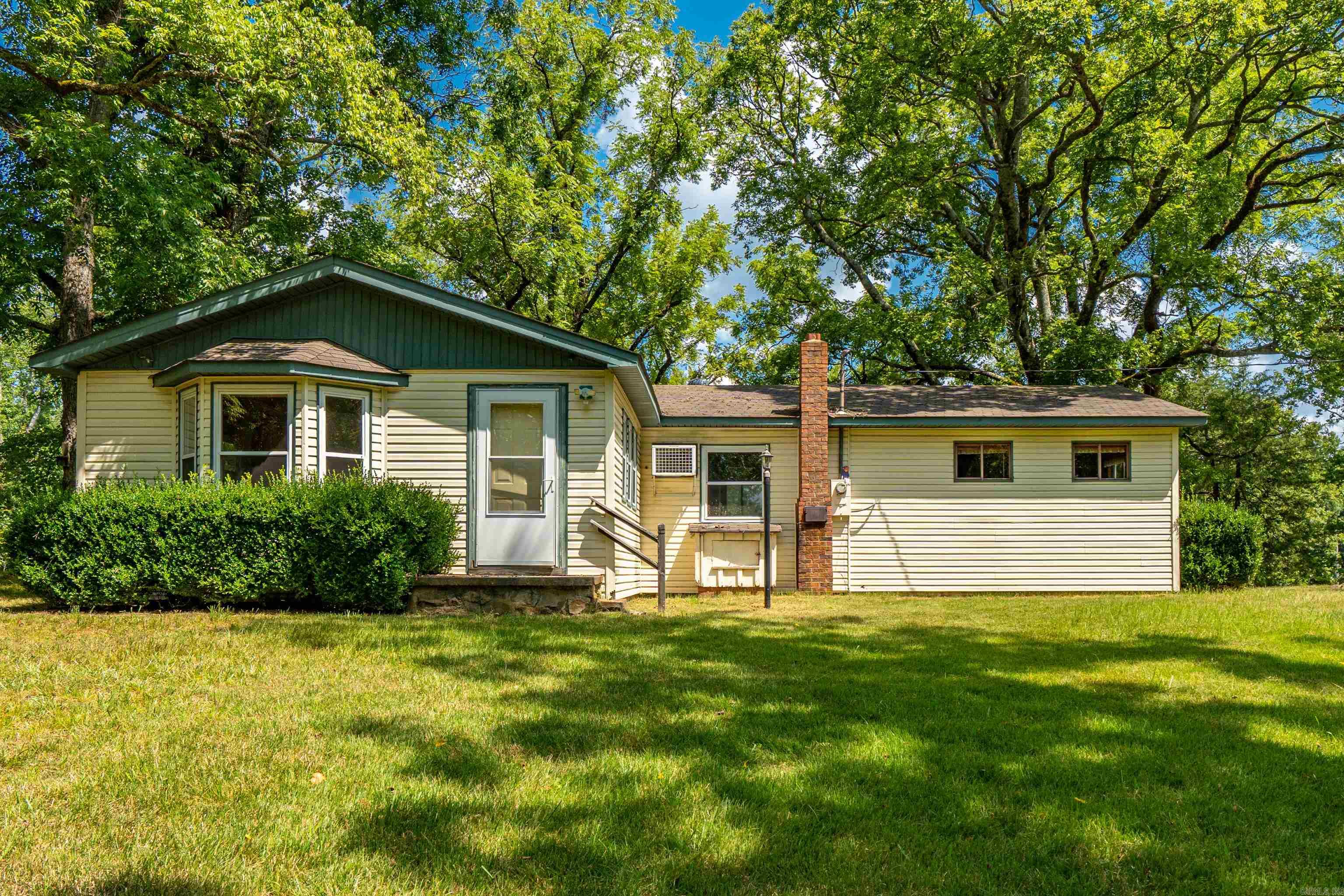 Serenity with a side of sweat equity! Located in Lake Hamilton School District, this 2+ bedroom, 1.5 bath mystery box sits on 7.92 glorious, unrestricted acres—meaning you can build a second house, a yurt, a goat palace, or just do donuts on your tractor. No HOA here, folks. You're the mayor of this mini kingdom. Inside? Well… let’s just say it’s a "complete fixer-upper"—which is Realtor™ code for “bring a dumpster, a contractor, and possibly a priest.” The property is ever-so peaceful. The kind of views that make you question your life choices… but in a good way. Watch the sunrise with coffee or the sunset with a glass of something stronger after trying to patch drywall for six hours. The small pond contains water, wonder, and possibly amphibious neighbors who will not pay rent but will judge your choices. This is not just a house - it's a journey! An adventure of questionable logic but infinite reward. Bring your imagination, your grit, and your best overalls. Greatness (and probably sawdust) awaits. (SEE AGENT REMARKS)