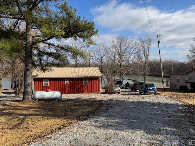 ADORABLE HOME ON CURRENT RIVER!!  This 1000 square foot home has all the rustic charm you’d expect on a river home! 2 bedrooms plus a loft for a queen size mattress, updated bathroom, living room-dining-kitchen combo plus a sun room and laundry area! Heat and air can be mini split unit, wood stove fireplace insert or ventless gas heater. Stove, refrigerator, microwave, washer and dryer all stay. LVP floors. Lot is .41 of an acre with 109 feet of river frontage. Floating boat dock, private boat ramp for subdivision use, surveyed and 10X12 storage building. Clay County Rural Water, septic system, LP Gas, Clay County Electric and Clay County Connect Fiberoptic Internet. 21 miles to Pocahontas and 19 miles to Doniphan. Has never flooded per owner!