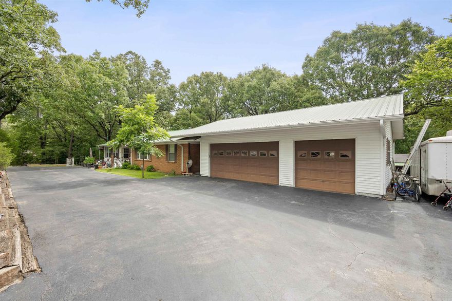 Well maintained country home nestled close to Lake Poinsett and situated on Crowley's Ridge in Harrisburg, Arkansas. This spacious property offers 3 bedrooms and 2 baths, providing ample space for comfortable living. As you approach the property, you'll be greeted by a convenient circle drive, making parking a breeze. The large shop with a lean-to is perfect for those who enjoy tinkering or need extra storage space. Additionally, the property features a gazebo, providing a tranquil spot to relax and enjoy the surrounding natural beauty. The loft above the second garage offers endless possibilities, whether you envision it as a home office, hobby space, or even a guest suite. It also has a half bath. Step outside onto the covered deck and take in the picturesque views of the 3.4 +/- acre property. The abundance of fruit trees, including peach, apple, and pear, along with blackberries, adds a touch of nature's bounty to your backyard. Inside, the recently remodeled primary bedroom and primary bath offer a modern and luxurious retreat. The large kitchen is a cook's dream, complete with a natural gas cook stove and picture window. All appliances remain.