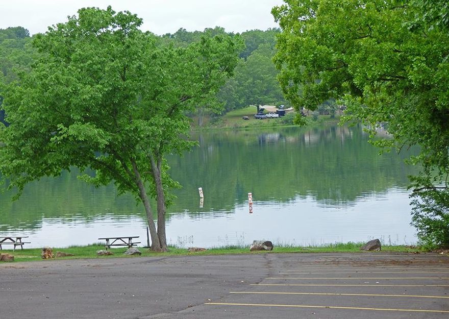 Take advantage of this wooded lot with a great view of Lake Sequoyah.  Steps away from the beach of Giuchie Gumee.  Water and electric in the area.