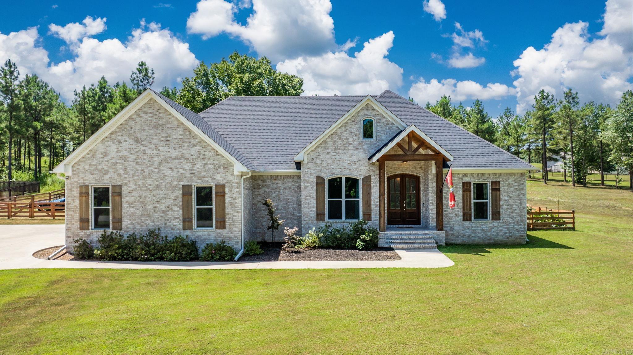 AN ABSOLUTE SHOW-STOPPER! An immaculate, 4 bed, 2 bath home on 1.68 acres with an above ground pool, HUGE pool deck, covered back patio w/ pergola, storm shelter, fenced-in backyard, garden beds with producing vegetables, fireplace, insulated two-car garage, and a cleared area for your future shop or tiny house! This property has NO RESTRICTIONS! You will walk in to an open floor plan with high ceilings and a view of your landscaped yard and pool area. The primary bedroom is massive, has a wooden tray ceiling, and has a barn door to the bathroom to maximize space. The tile in the primary shower is a work of art and has plenty of space to move. You'll enjoy a large soaker tub and double vanities as well as the laundry room that is connected to your MASSIVE walk-in closet! The kitchen has beautifully lit upper cabinets, a plethora of drawers and cabinets, and your dream walk-in pantry for all of your groceries AND kitchen gadgets! There is an expanded driveway to park and an extra driveway to pull on the other side of the yard. I could list so many more features, but I am running out of room. Seriously, get over here and see this one, because it's even better than the photos.