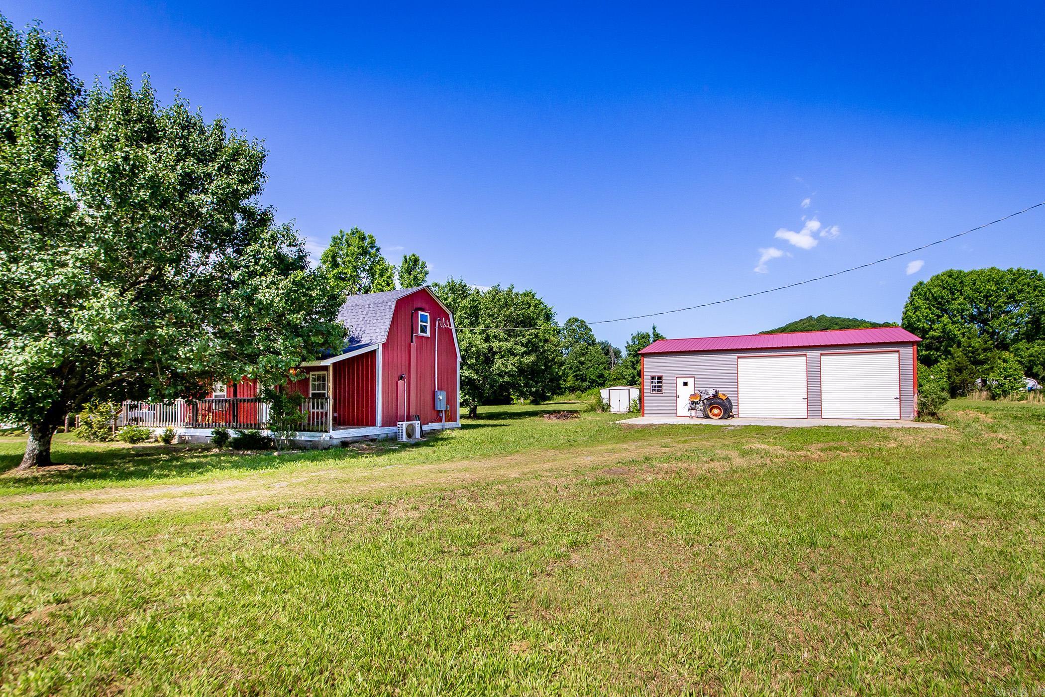 As you pull up the drive, you’re immediately charmed by the rustic beauty of this home, complete with a spacious front porch perfect for rocking chairs and sweet tea evenings. The property opens up to 3.93 acres of peaceful countryside, featuring a serene pond and a massive 20x 40 two bay shop with a car lift and 220amp outlets- ideal for hobbies or storage. Step inside to a sunlit living room where natural light bounces off gorgeous hardwood floors that run throughout the home. The open kitchen and dining space is cozy yet functional, with crisp white cabinets, stainless steel appliances, and plenty of room to gather. With two bedrooms and 1 bathroom, this home offers simple, stylish living in a serene setting. Whether you’re looking to downsize, start your homestead, or just escape the hustle, this one has all the charm and space you need!