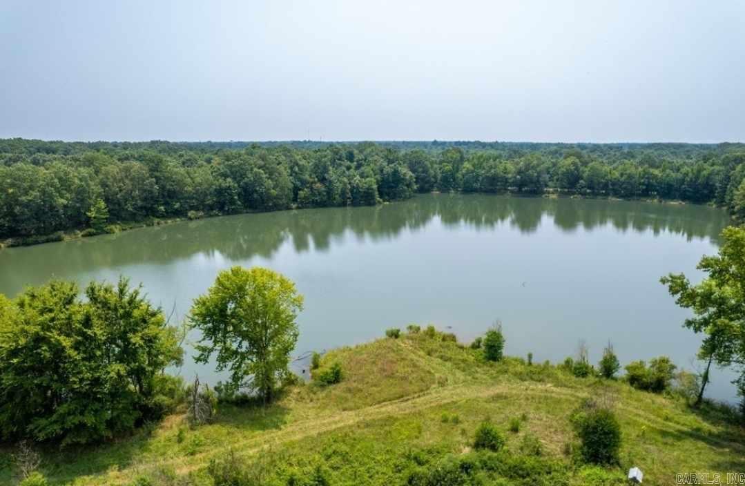 Discover this remarkable property with a 10-acre private, spring-fed lake. A great spot for fishing, boating and swimming! This is a fantastic opportunity to own your personal oasis close to town and amenities. Utilities available at the road. Property has been surveyed and property corners marked. There is an old homestead on property that is not considered of any value.