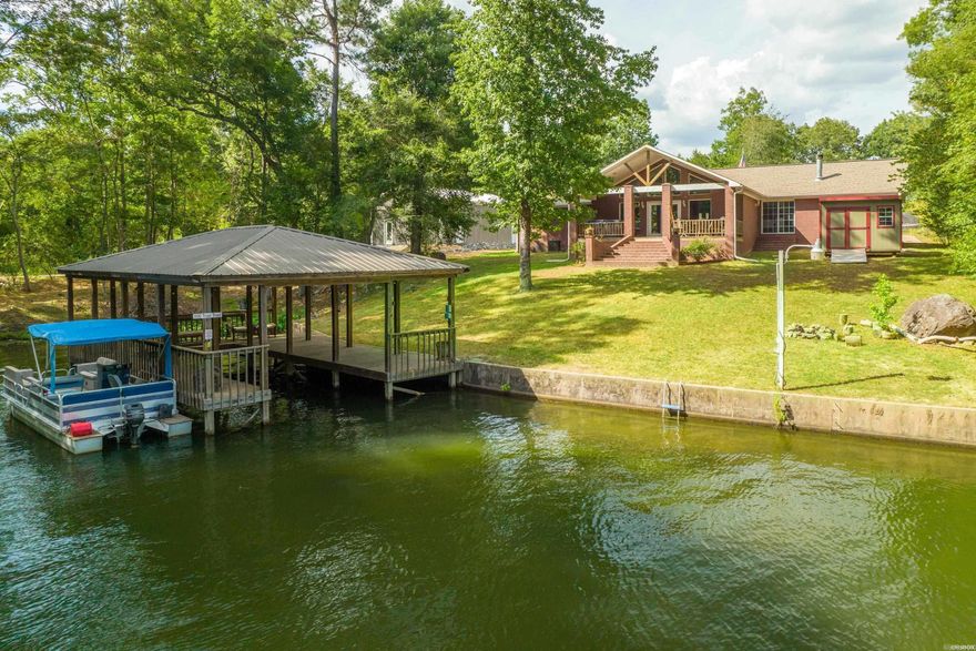 Exceptional Lake Hamilton Home with Boat Dock.  Located outside the city limits. Make this your gorgeous home OR outstanding investment opportunity in the booming short-term rental market. This is a fully operational and highly profitable property available for sale, offering you a turnkey solution to capitalize on the ever-growing demand for short-term accommodations. Start earning from day one. Features 4 bedrooms, 2.5 baths. Tastefully decorated, fully equipped kitchen with Granite counters & selling fully furnished.  Call today to schedule your tour of this beautiful property.
