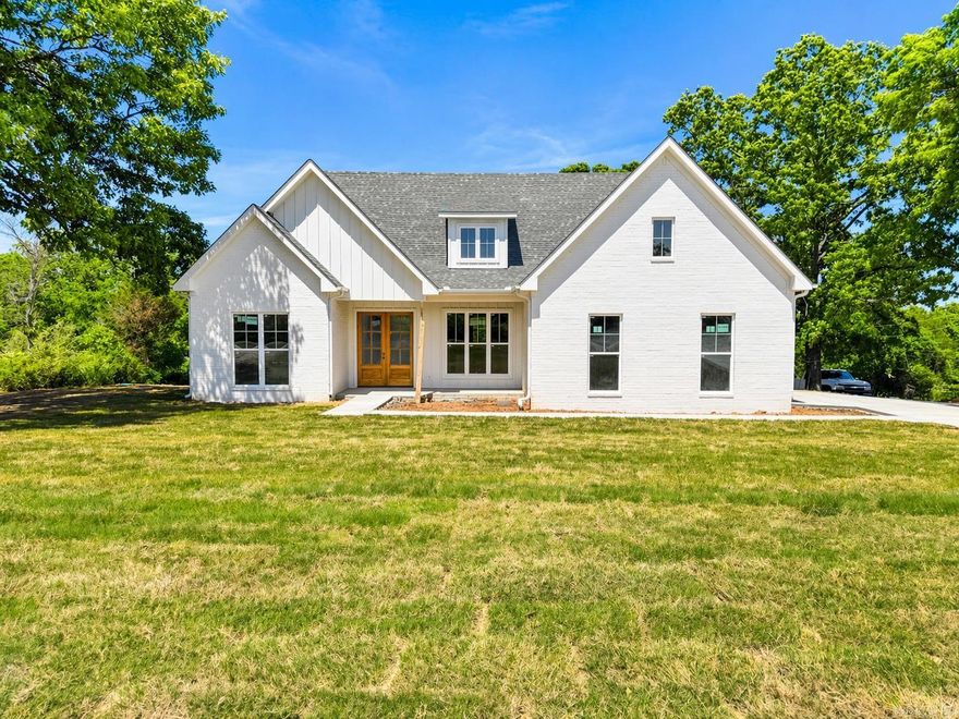 Welcome to your dream home! This new Modern Farm construction is only weeks away from being perfected. Offering a stunning blend of modern design, classic farmhouse charm, and warm Honey Oak wood floors, that truly make this house feel like your home. Built with longevity in mind, the exterior features brick, LP SmartSide siding, with cedar and wood accents. The massive double door entry leads you to an open interior with soaring cathedral ceilings, a Chef style kitchen with an island, lots of counter and cabinet space, pantry, a mud area just off the garage entrance, and a dining area that can accommodate a full-size table. The Primary Bedroom also features a cathedral style ceiling with wood beaming and a Primary Ensuite with a tiled shower and separate soaker tub. Sitting on a corner lot with over an acre of property, this home provides ample space for a shop, or maybe a pool, outdoor activities, gardening, and relaxation under the covered back patio. The nice wide driveway leads you to a side entry garage. Enjoy out of city limits but still close to amenities, shopping, and restaurants. Please see Agent Remarks.