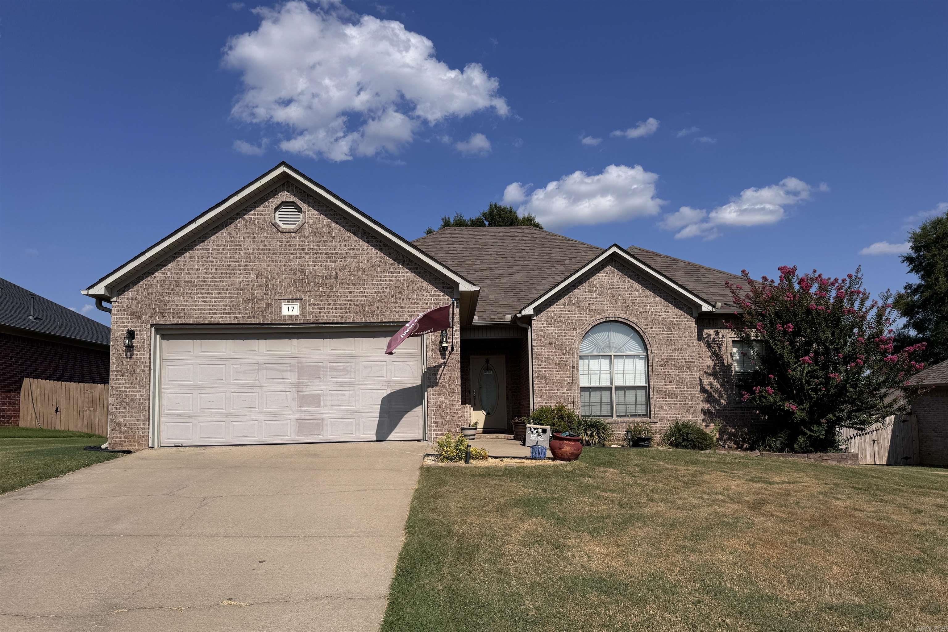 Charming brick home in Magness Creek North Subdivision. This 3BR, 2BA home is perfect for your family, featuring a nice living room with fireplace and hardwood flooring, beautiful tray ceilings in both living room and primary bedroom, a newly stained deck and large backyard for outdoor enjoyment. The large kitchen offers stainless appliances, breakfast bar, abundant cabinets and counterspace. Large Primary bedroom offers 2 walk-in closets, bath has 2 sinks, jetted tub and walk-in shower. Recent updates include new A/C, toilet, garage and opener, luxury vinyl flooring and vent in primary bathroom. Roof is about 10 years old, storage building and refrigerator stays. Bidet and outdoor grill do not convey. Please Read Showing Remarks
