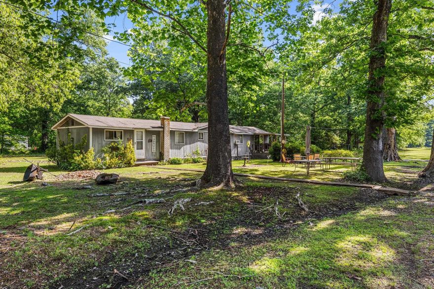 Tired of searching for the perfect land?! Get the best of country living and convenience with this beautiful 10-acre property featuring partial clearing and endless potential. Utilities are already in place, making this an excellent opportunity for a future homesite, hobby farm, or investment property. The property includes an existing 1300 sq ft house and 32x42 shop building that convey with the sale, though little value is being given to the structures. A circle drive welcomes you onto the property, and a storm shelter adds extra peace of mind. Plenty of room to spread out, build, or enjoy the space just as it is. Agents see remarks!